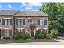 Charming stone townhouse featuring a well-manicured lawn and striking wood shutters at 1625 Bibury Ln, Charlotte, NC 28211