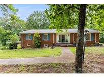 Charming brick home with a well-maintained lawn and inviting front entrance at 16453 Nc Hwy 73 Hwy, Albemarle, NC 28001