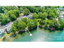 Beautiful aerial view of the lakefront condos with a private pier and lush green trees at 302 Northwest Dr, Davidson, NC 28036
