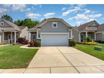 Charming single-story home boasts a two-car garage, manicured lawn, and inviting curb appeal at 5141 Grandview Dr, Fort Mill, SC 29707