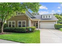 Charming home with a well-manicured lawn, tidy shrubbery, and an attached two-car garage at 5428 Colonial Garden Dr, Huntersville, NC 28078