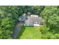 An aerial view showcases the home with its expansive yard and surrounding lush greenery, offering a sense of privacy and space at 611 W Robinson St, Dallas, NC 28034