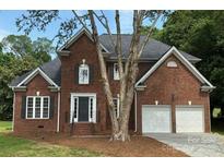 Beautiful brick two story house with manicured lawn and an attached two car garage at 111 Billy Joe Rd, Mooresville, NC 28117