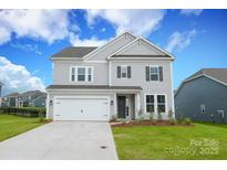 Charming two-story home with a well-manicured lawn and attached two car garage at 1190 Sugar Creek Rd, Fort Mill, SC 29707