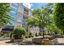 Stunning exterior view of the building with beautiful landscaping and benches for outdoor seating at 1315 East Blvd # 611, Charlotte, NC 28203