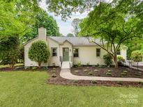 Charming single-story home with a well-manicured lawn and beautiful landscaping with a walkway leading to the front door at 138 Shepherd Rd, Mooresville, NC 28115