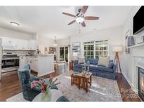 Open-concept living room with dark wood floors and a view into the kitchen at 16121 Wrights Ferry Rd, Charlotte, NC 28278