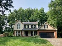 Charming two-story home with a lush green lawn and mature trees enhancing its curb appeal at 2222 Raven Dr, Rock Hill, SC 29732