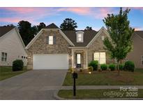 Charming home with a stone and brick facade, manicured lawn, and a two-car garage at 2236 Prairie Rd, Concord, NC 28027