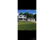 Charming two-story home with landscaped yard and white siding at 2412 Elizabeth Ave, Staley, NC 28150