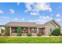 Charming brick home with stone accents, covered front porch and beautifully landscaped front yard at 2843 Startown Rd, Lincolnton, NC 28092