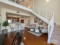 Open-concept living space with modern kitchen and beautiful wood floors at 300 W 5Th St # 723, Charlotte, NC 28202