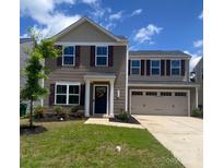 Charming two-story home featuring a well-maintained lawn and a two-car garage at 3113 Bouquet St, Charlotte, NC 28215