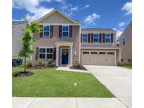 Charming two-story home with a well-manicured lawn, colorful landscaping, and a two-car garage at 3113 Bouquet St, Charlotte, NC 28215