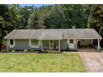 Charming single-story home with a well-manicured front yard, inviting entrance, and convenient carport at 312 Walton Dr, Statesville, NC 28625
