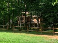 Charming two-story brick home with a well-manicured lawn and a classic wooden fence at 3513 Briarcliff Acres Dr, Lincolnton, NC 28092