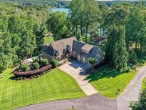 Expansive aerial view of a grand estate featuring a manicured lawn, lush greenery, lake, and a swimming pool at 4290 Barbrick St, Sherrills Ford, NC 28673