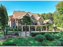 Beautiful lakefront home boasts mature landscaping and an inviting backyard pool at 4290 Barbrick St, Sherrills Ford, NC 28673