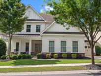Charming two-story home featuring a welcoming front porch and beautifully landscaped front yard at 435 Galbreath Ct # 128, Fort Mill, SC 29708