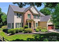 Beautiful two-story home featuring lush landscaping, neutral paint, and an attached two-car garage at 6206 Glencairn Ct, Charlotte, NC 28269