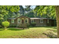 Charming home with inviting entrance, well-maintained lawn, and mature trees providing a peaceful setting at 8321 Walkup Rd, Waxhaw, NC 28173
