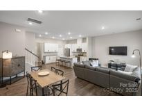 Inviting open-concept living space with a kitchen island, dining area, and cozy living room at 8928 Morning Mist Rd, Charlotte, NC 28215