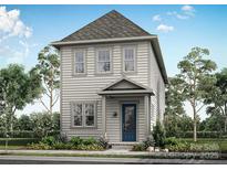 Charming two-story home with a blue front door and beautifully landscaped front yard and gray siding at 9109 Maybry Park St # Lot 115, Charlotte, NC 28212