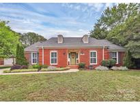 Charming single-story brick home with a well-manicured lawn and inviting front entrance at 10024 Tealridge Ln, Charlotte, NC 28277