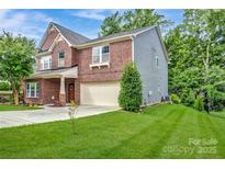 Charming two-story home featuring a combination of brick and siding, a well-manicured lawn, and an attached two-car garage at 1017 Quail Run Ct, Indian Land, SC 29707
