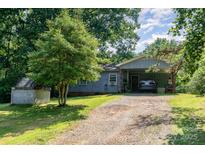 Charming single story home featuring a carport and mature trees at 142 Idlebrook Rd, Statesville, NC 28677