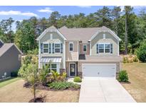 Charming two-story home featuring a two-car garage, landscaped yard, and inviting curb appeal at 14611 Murfield Ct, Charlotte, NC 28278