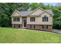 Inviting two-story home featuring a well-maintained lawn and a mix of brick and siding exterior at 1520 28Th Sw St, Hickory, NC 28602