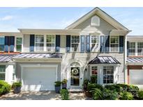 Charming two-story townhome with a light gray exterior, a black metal roof accent, and an attached garage at 1644 Backcreek Ln, Gastonia, NC 28054