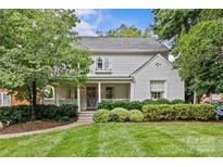 Charming two-story home with manicured lawn and lush landscaping creating inviting curb appeal at 2814 Glendale Rd, Charlotte, NC 28209