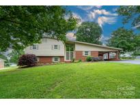 Charming split level home with a well-manicured front yard and covered parking at 318 Confederate Sw Dr, Concord, NC 28027