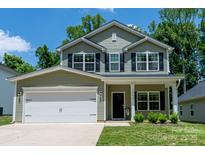 Charming two-story home with sage siding, black shutters, a covered front porch, and a two-car garage at 3403 Keith Dr, Charlotte, NC 28269