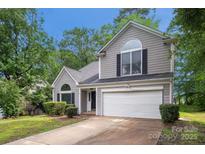 Charming two-story home with a well-maintained front yard, attached two-car garage, and beautiful trees at 3826 Yorkford Dr, Charlotte, NC 28269