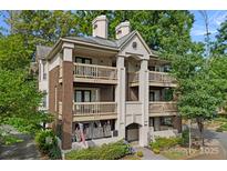 Stunning condo building with brick and painted accents, multiple decks, manicured landscaping, and a welcoming entrance at 409 W 8Th St, Charlotte, NC 28202