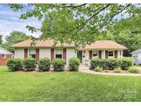 Charming single-story home with brick accents, lovely landscaping, and a welcoming front entrance at 5929 Brookhaven Rd, Charlotte, NC 28210