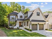 Stunning two-story home featuring a brick facade, attached garage, and professionally landscaped front yard at 6013 Camile Ct, Charlotte, NC 28226