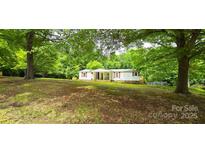 Charming single-story home featuring a covered front porch and a well-maintained lawn with mature trees at 6140 Barclay Ln, Clover, SC 29710