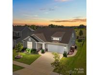 Inviting single-Gathering home showcases beautiful landscaping and a well-manicured lawn at sunset at 6531 Wildbrook Dr, Charlotte, NC 28269