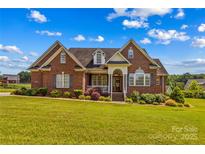 Charming, two-story brick home featuring a well-manicured lawn and inviting front porch at 1070 Blueberry Rd, Salisbury, NC 28147