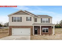 Charming two-story home featuring a brick-accented facade, attached garage, and covered front porch at 11131 Cardinal Creek Ave, Charlotte, NC 28215