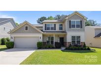 Charming two-story home with a well-manicured lawn, neutral siding, and an attached two-car garage at 1814 Still Water Ln, Fort Mill, SC 29707