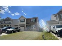 Charming two-story home with manicured lawn, inviting entrance, and attached one car garage at 189 Fesperman Cir, Troutman, NC 28166