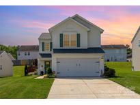 Charming two-story home with a well-maintained lawn, green shutters, and a two-car garage at 2636 Forest Grove Ct, Charlotte, NC 28269