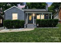 Charming brick home featuring a cozy front porch with well-manicured landscaping and inviting curb appeal at 432 4Th Street Sw Pl, Hickory, NC 28602