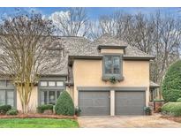Charming two-story home with gray roof, manicured landscape, and attached two-car garage at 5721 Ballinard Ln, Charlotte, NC 28277