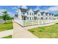 Charming townhomes with white picket fences, beautiful lawns, and impeccable landscaping at 651 Melville Dr, Rock Hill, SC 29732